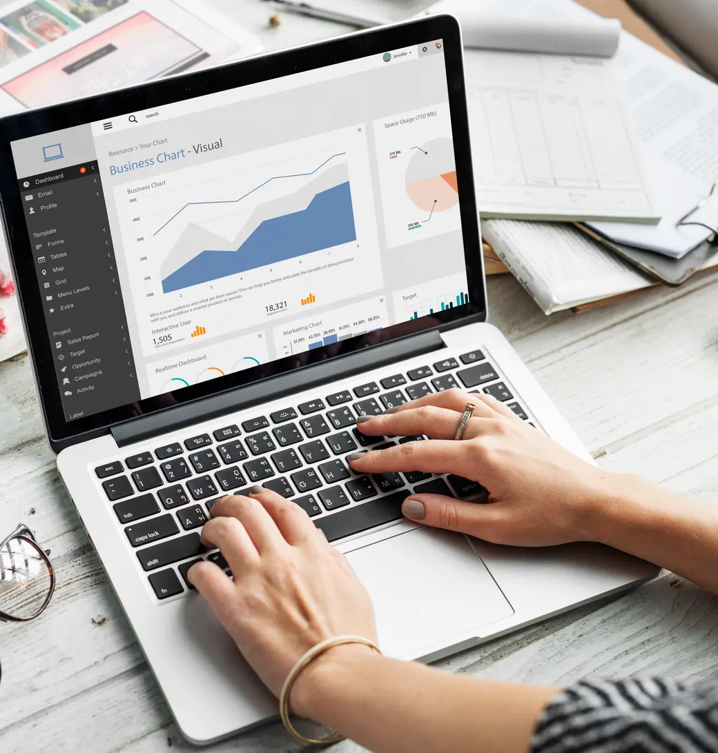 Marketer reviewing website traffic charts on a laptop